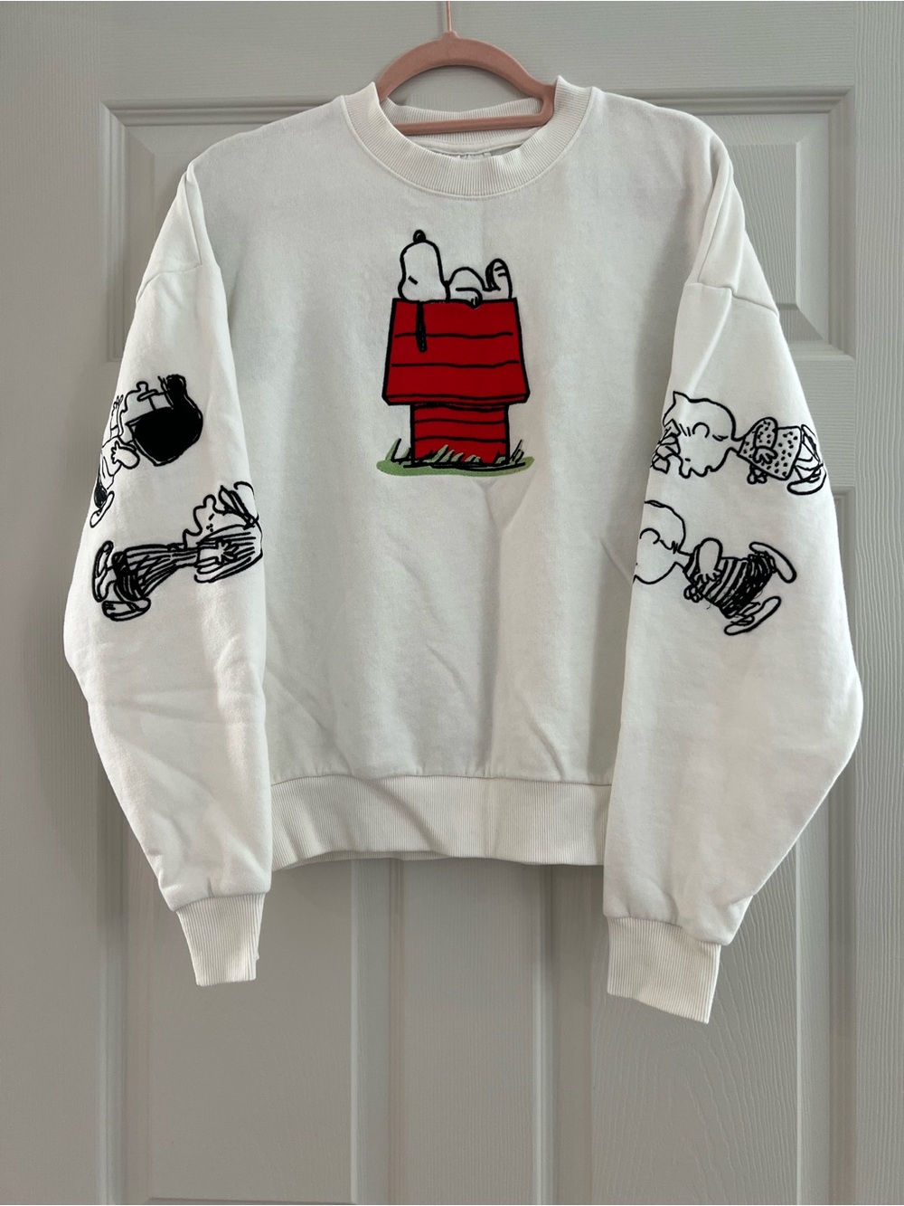 Peanuts White Crewneck Sweatshirt with Red Doghouse & Snoopy Graphics
